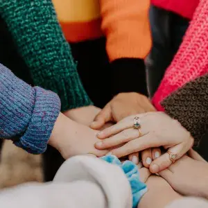 group of hands in a huddle